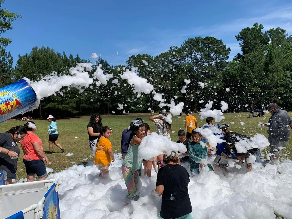 Campers in foam at an outdoor camp event