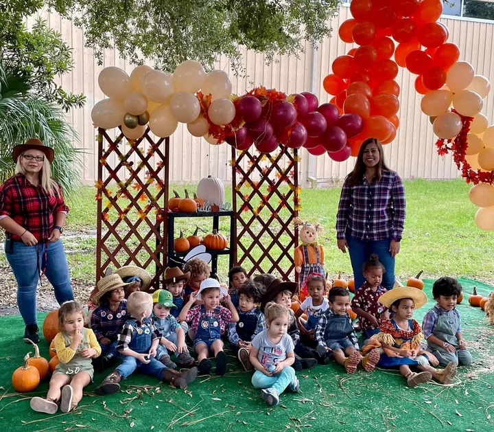 Preschoolers seated at a fall festival