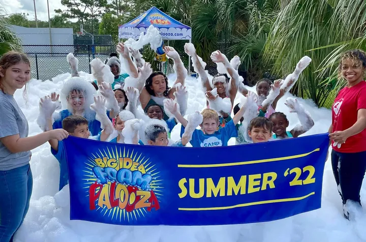 A summer camp group cheering in foam